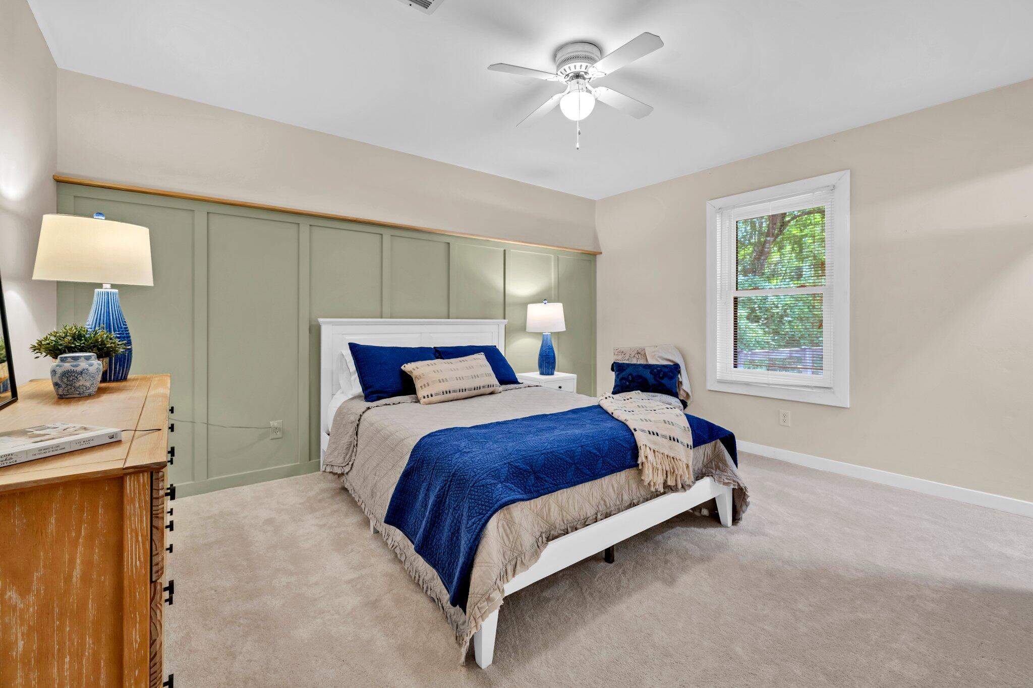 5241 Bob Sikes Road DeFuniak Springs, FL 32435 - Photo 3 of 35 a bedroom with a bed chandelier and a window