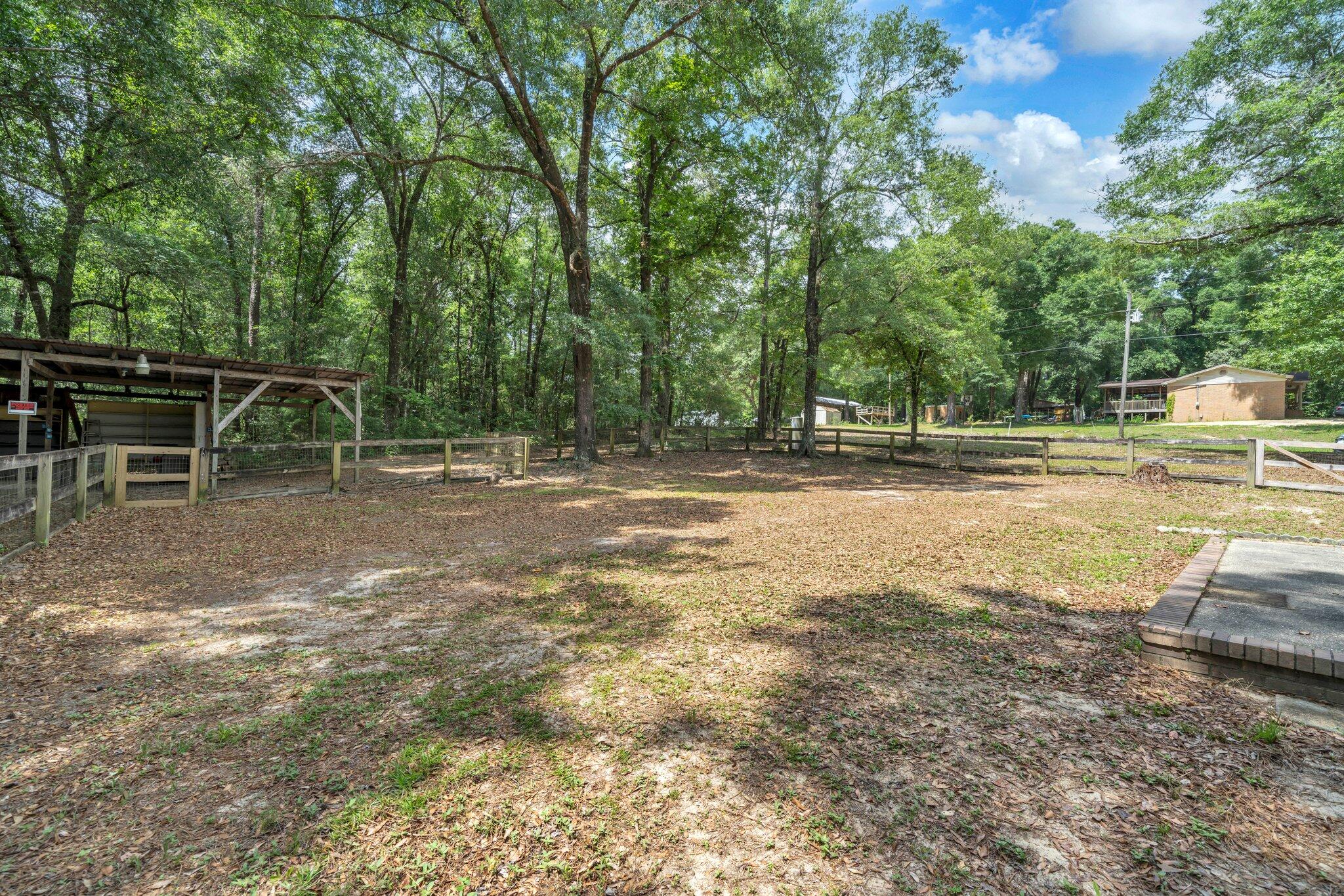 5241 Bob Sikes Road DeFuniak Springs, FL 32435 - Photo 31 of 35 a backyard of a house with lots of green space