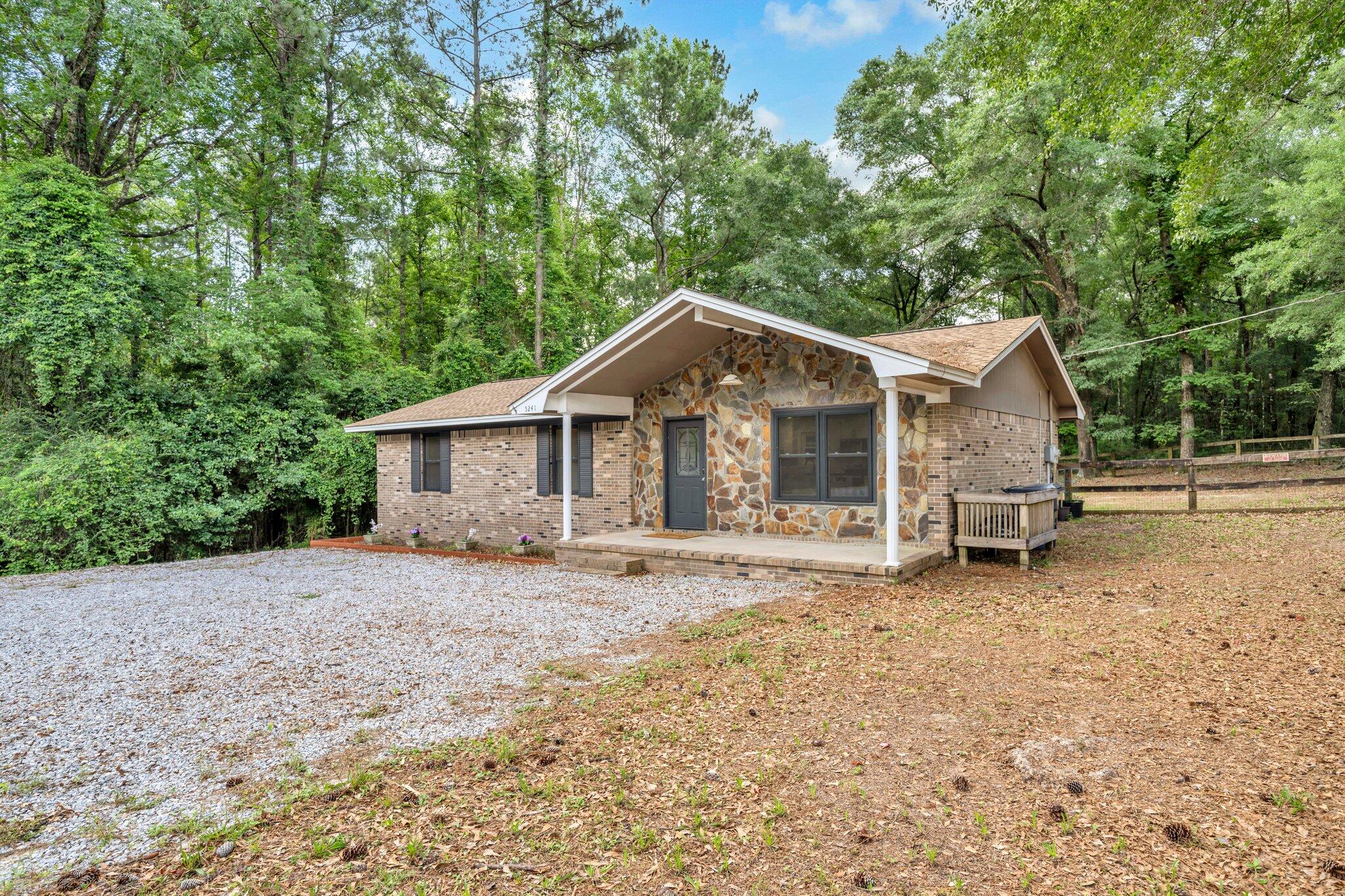 5241 Bob Sikes Road DeFuniak Springs, FL 32435 - Photo 5 of 35 a house with trees in the background
