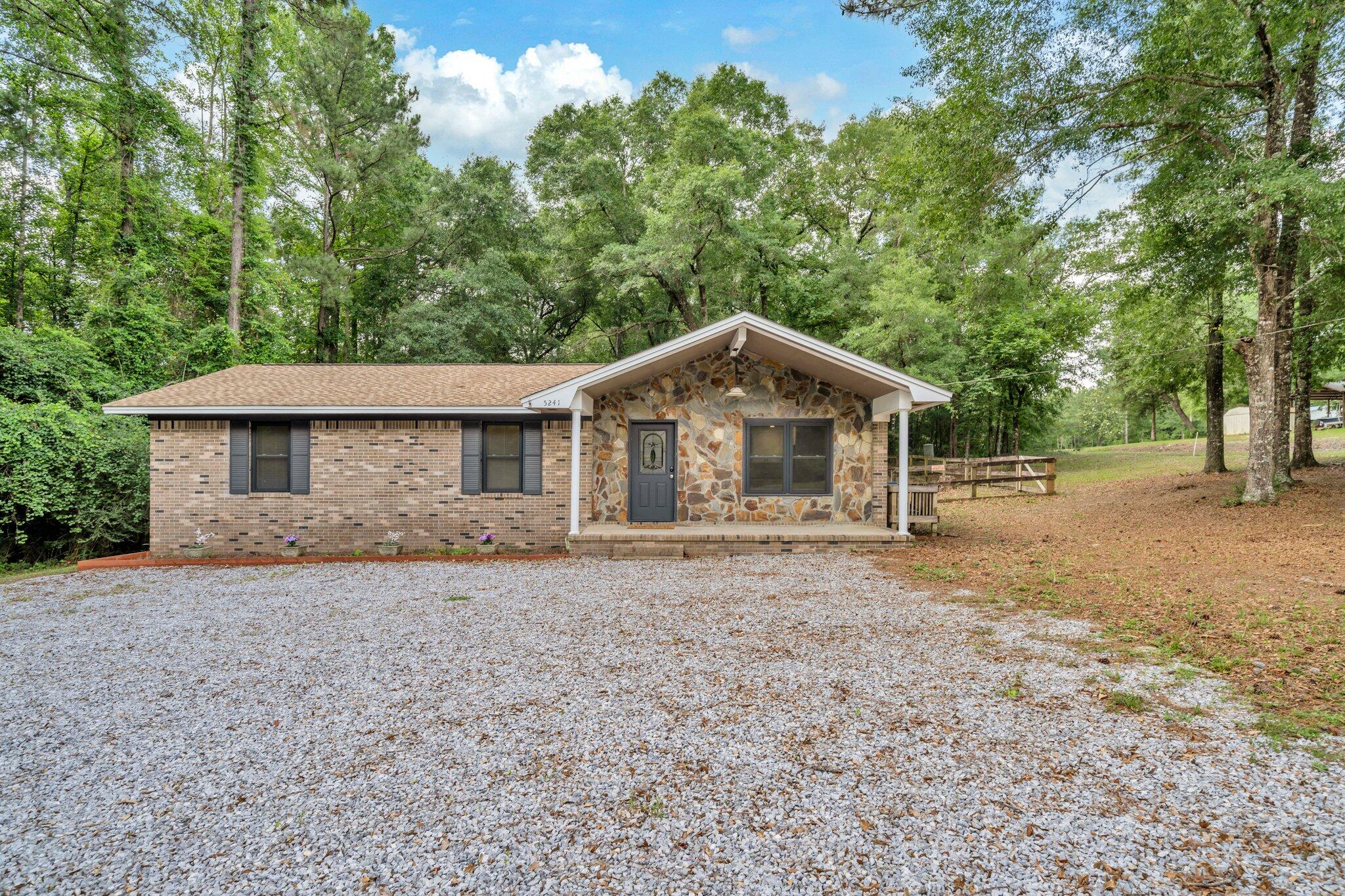 5241 Bob Sikes Road DeFuniak Springs, FL 32435 - Photo 7 of 35 a front view of a house with a yard