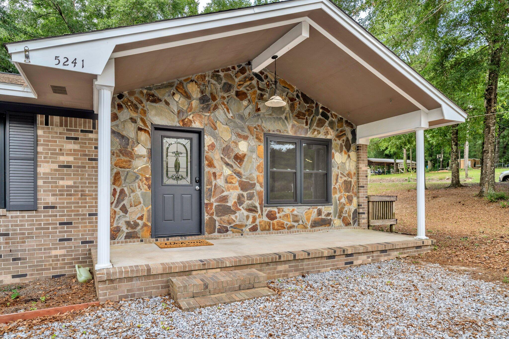 5241 Bob Sikes Road DeFuniak Springs, FL 32435 - Photo 8 of 35 a front view of a house with a yard