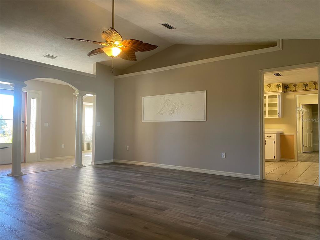 5881 Southwest 86th Place Ocala, FL 34476 - Photo 2 of 18 a view of an empty room with wooden floor and a window