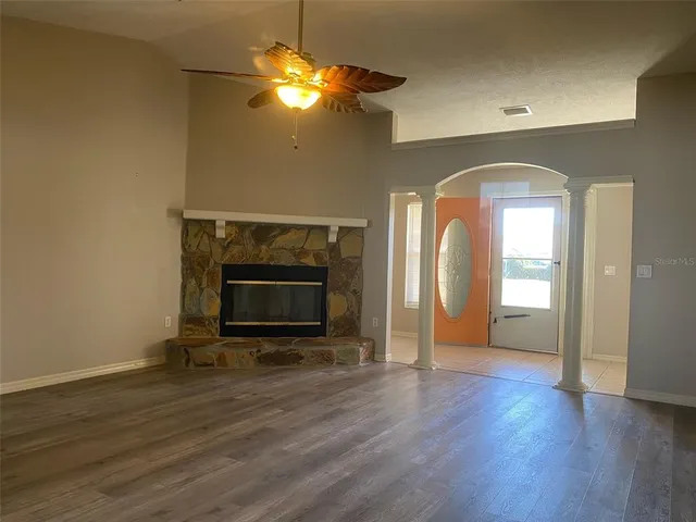a view of a livingroom with a fireplace and wooden floor