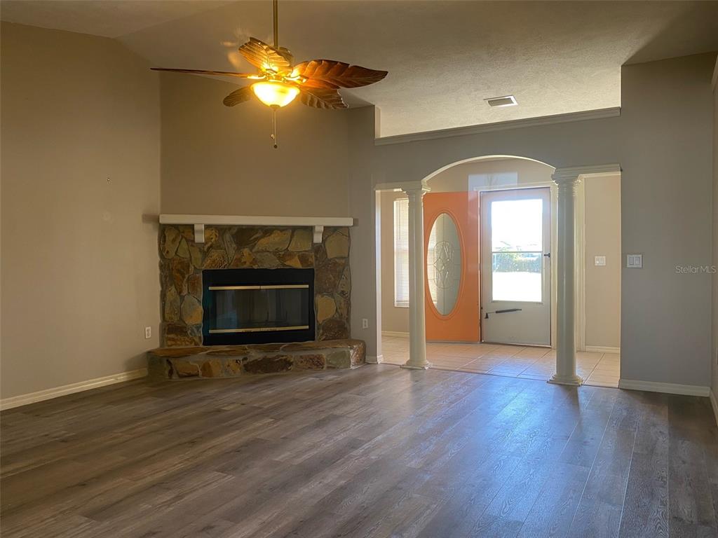 5881 Southwest 86th Place Ocala, FL 34476 - Photo 5 of 18 a view of a livingroom with wooden floor a fireplace and window