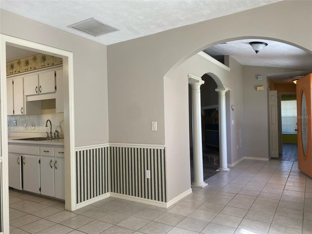 5881 Southwest 86th Place Ocala, FL 34476 - Photo 10 of 18 a view of a hallway and a livingroom with windows