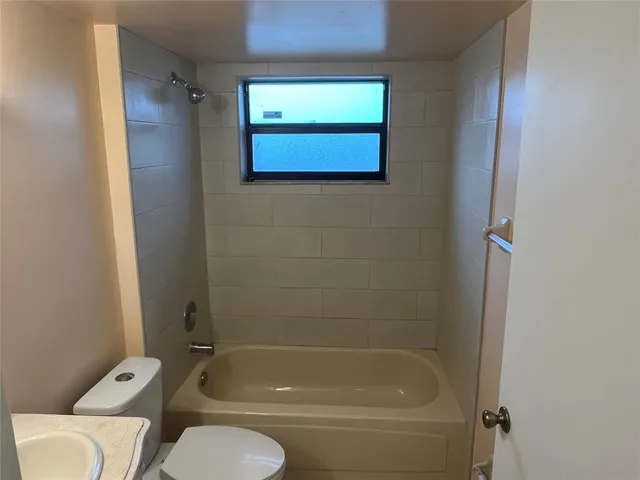 a view of a bathroom with a tub and toilet