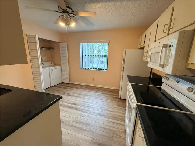 a kitchen with granite countertop a stove and a refrigerator