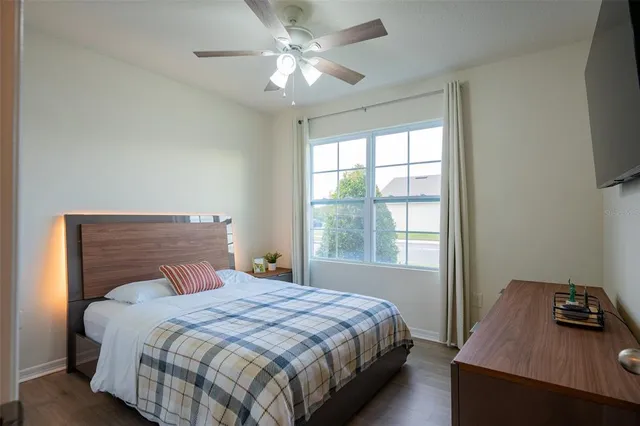 a bedroom with a bed and a window