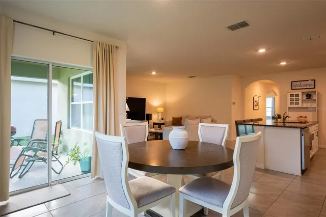 a view of a dining room with furniture and a potted plant