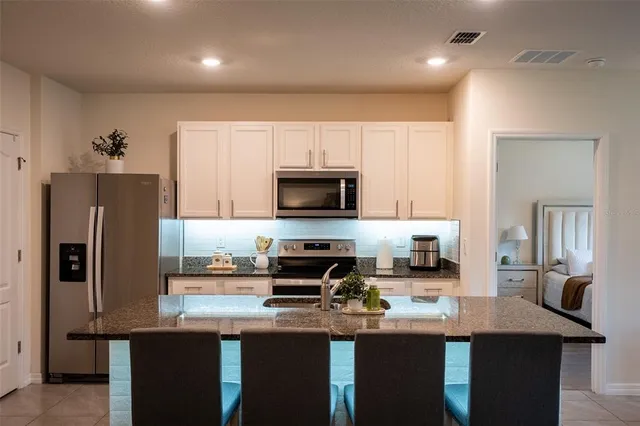 a kitchen with refrigerator and microwave