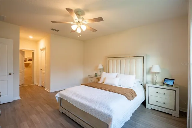 a bedroom with a bed and a chandelier
