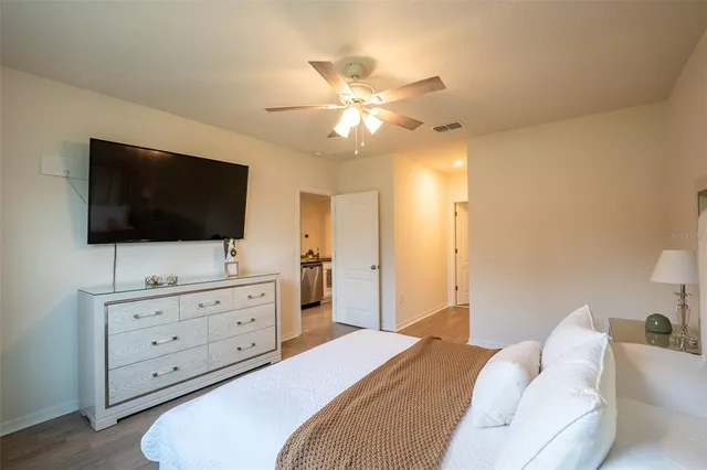 a bedroom with a bed and a flat screen tv