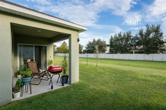 a view of a house with a backyard porch and sitting area