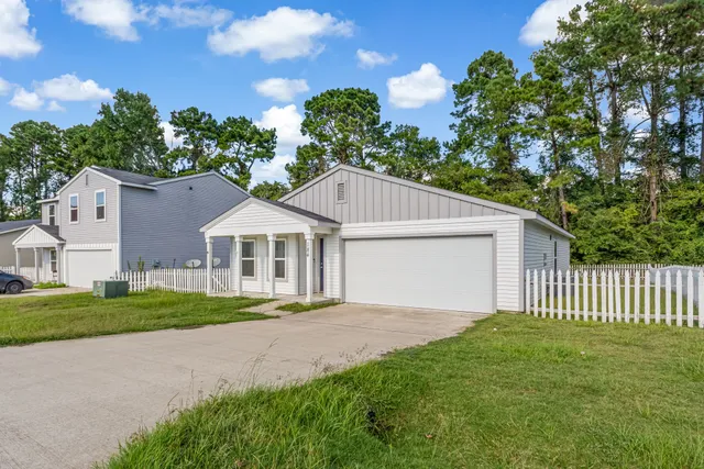 a front view of a house with a garden