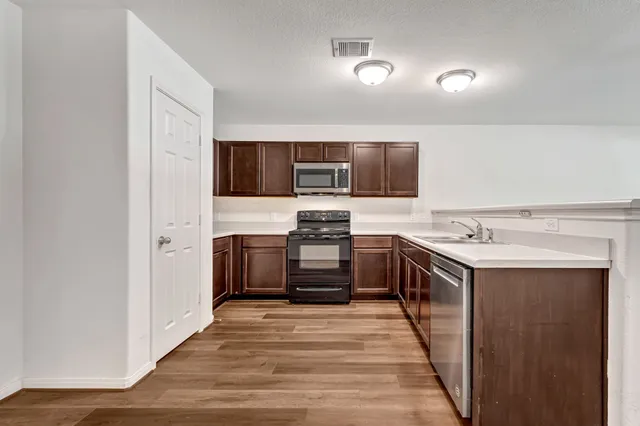 a kitchen with a stove and a refrigerator