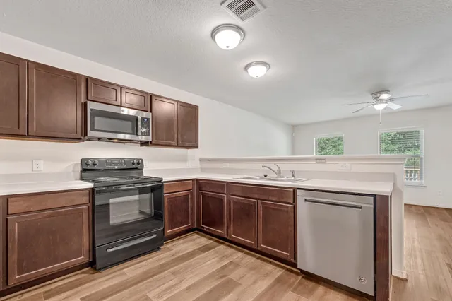 a kitchen with stainless steel appliances granite countertop a stove and a sink