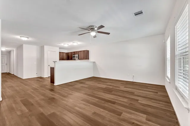 wooden floor in an empty room with a window