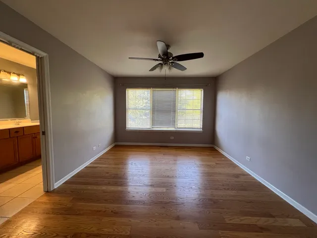 a view of room with window hardwood floor and ceiling fan