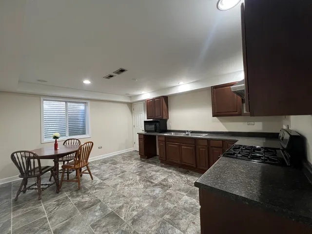 a kitchen with a stove and a refrigerator