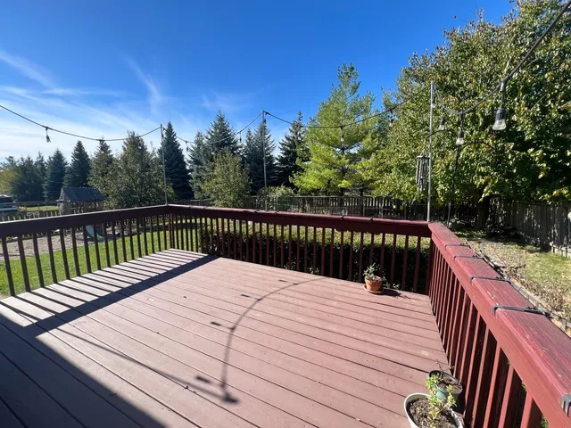 a balcony with wooden floor and fence
