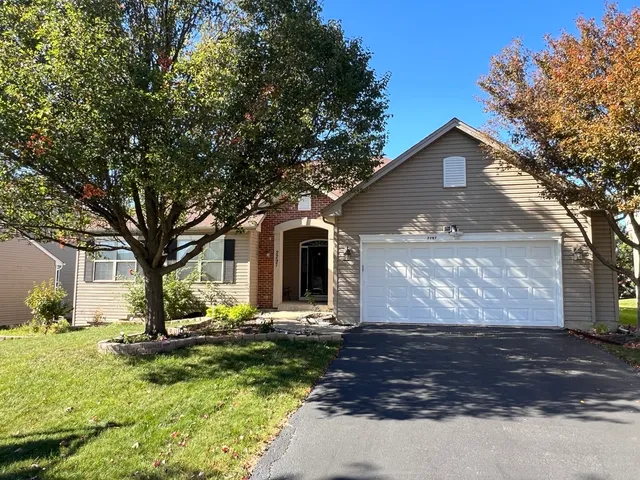 a front view of house with yard and green space