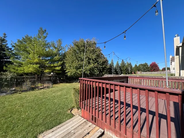 a view of balcony with wooden floor and outdoor seating