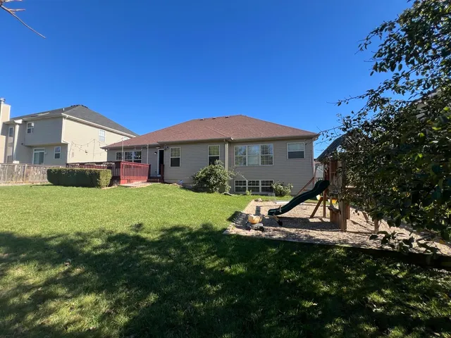 a view of a house with a yard porch and sitting area