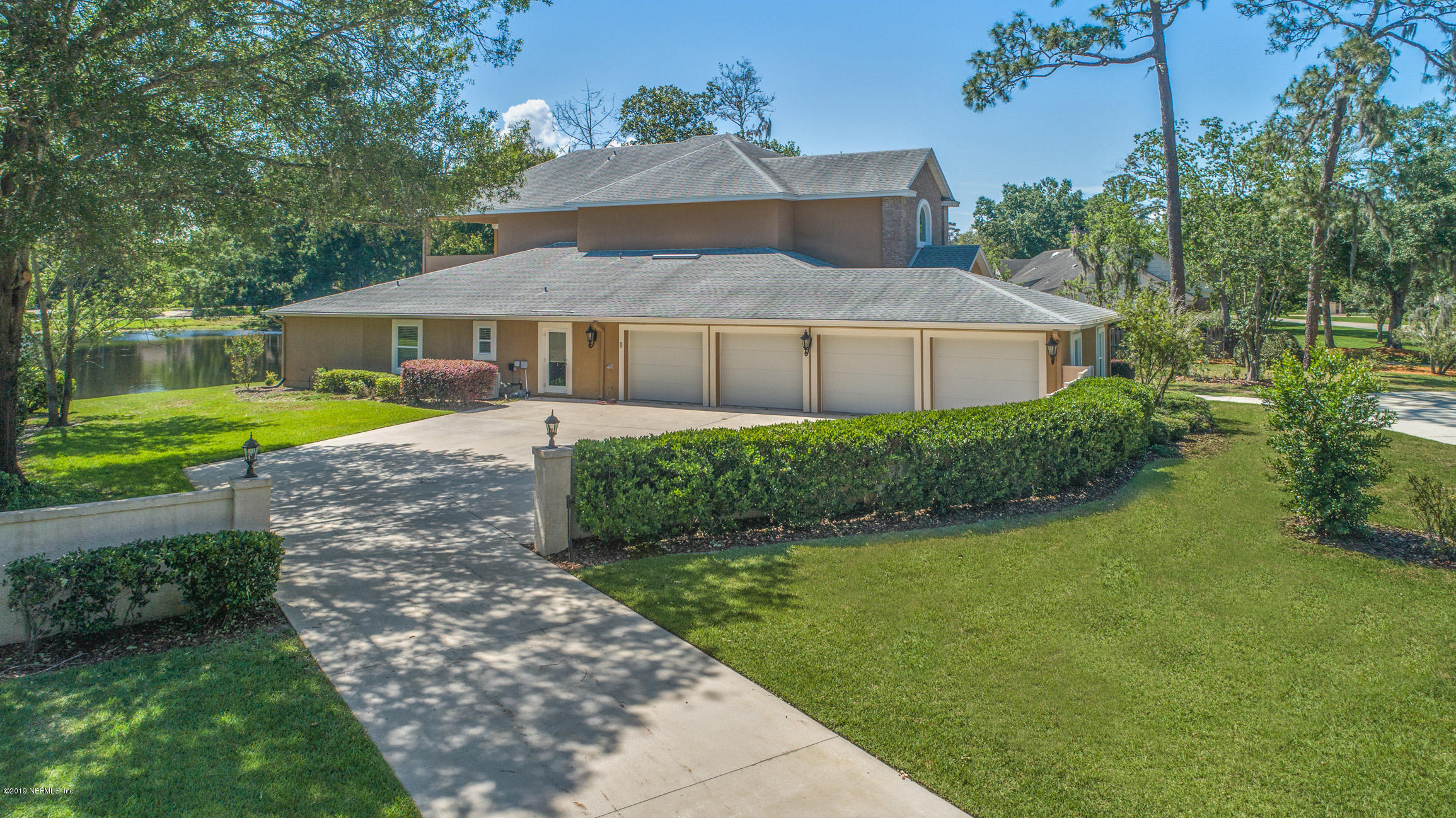 7936 Pine Lake Road Jacksonville, FL 32256 - Photo 11 of 70 a view of a house with a yard and potted plants