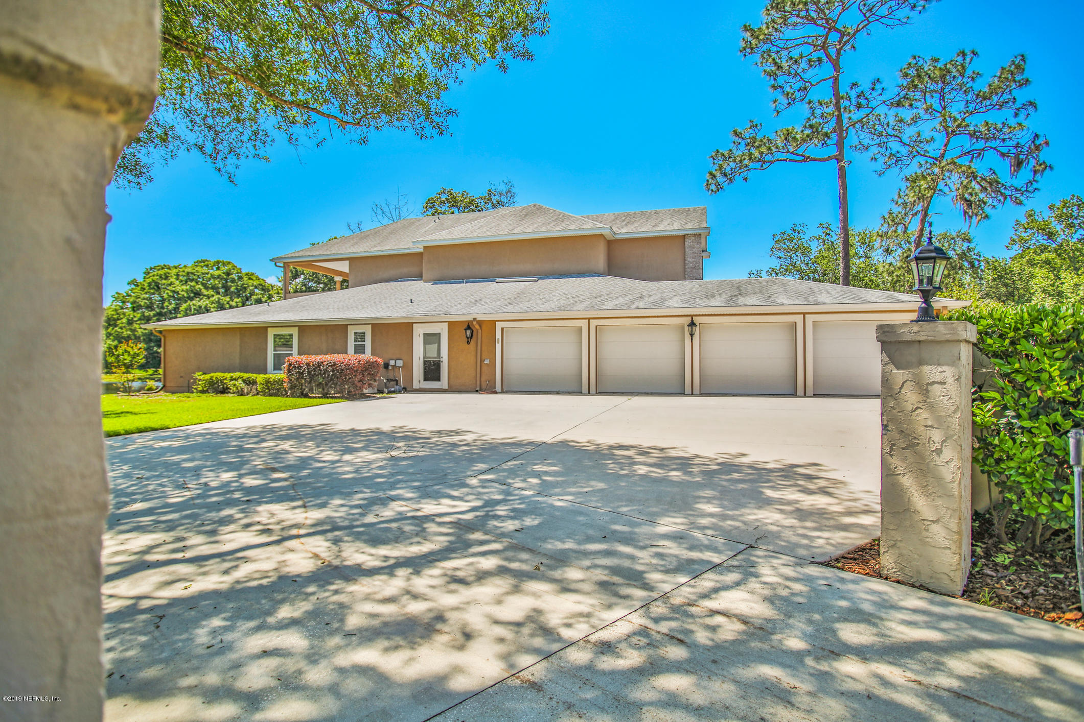 7936 Pine Lake Road Jacksonville, FL 32256 - Photo 12 of 70 a view of house with garden and tall trees