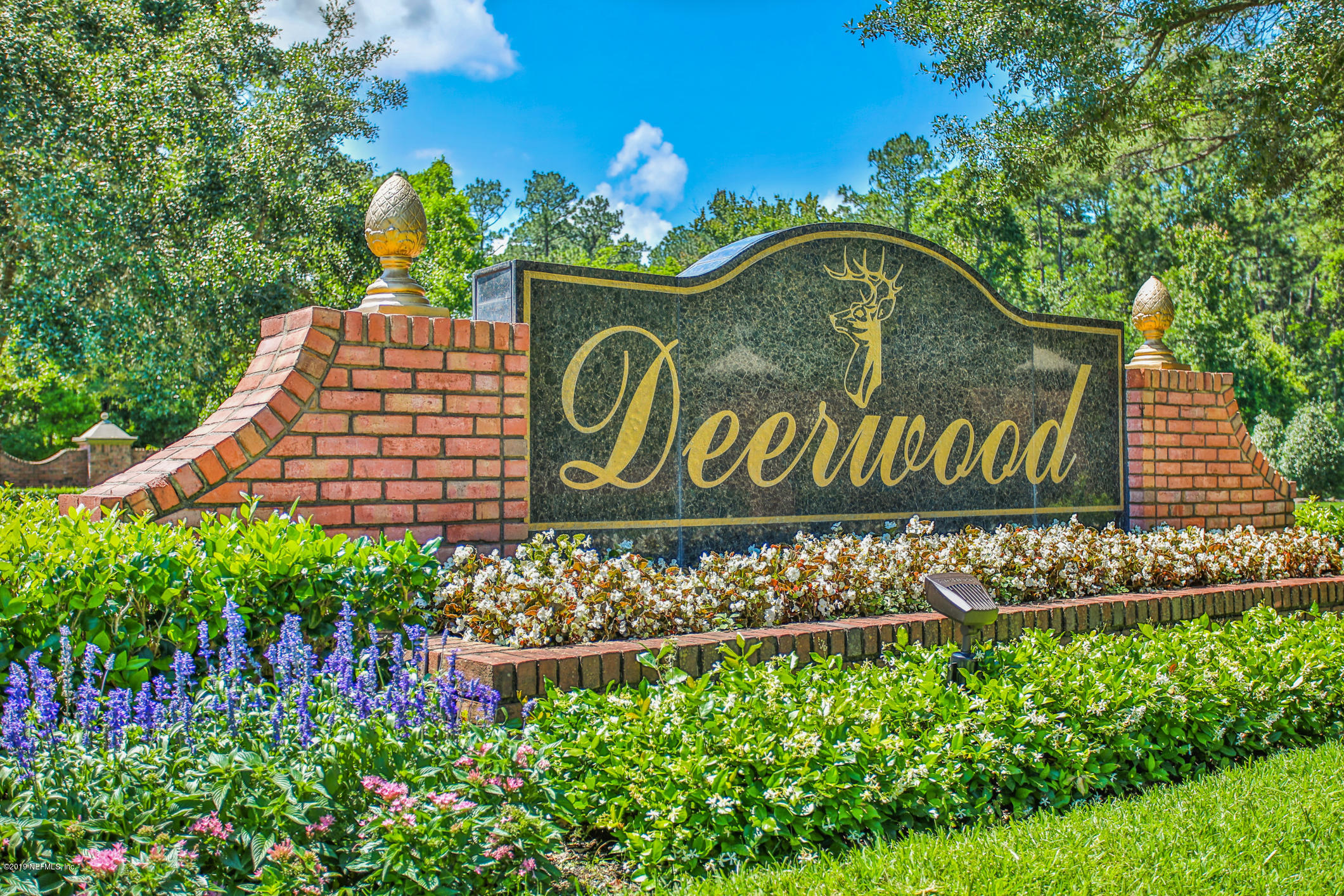 7936 Pine Lake Road Jacksonville, FL 32256 - Photo 2 of 70 a sign that is sitting in front of flowers