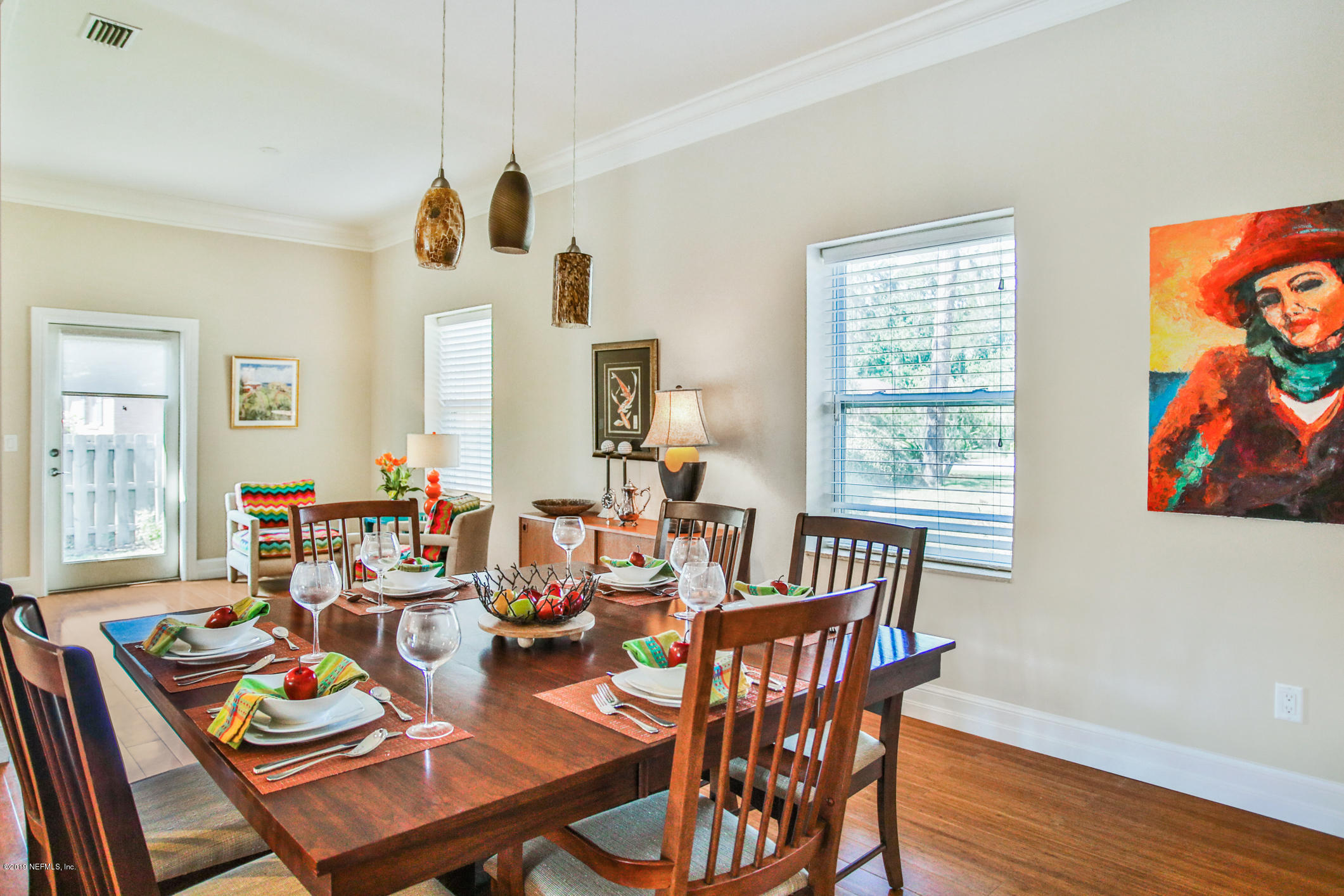 7936 Pine Lake Road Jacksonville, FL 32256 - Photo 21 of 70 a view of a dining room with furniture a chandelier and wooden floor