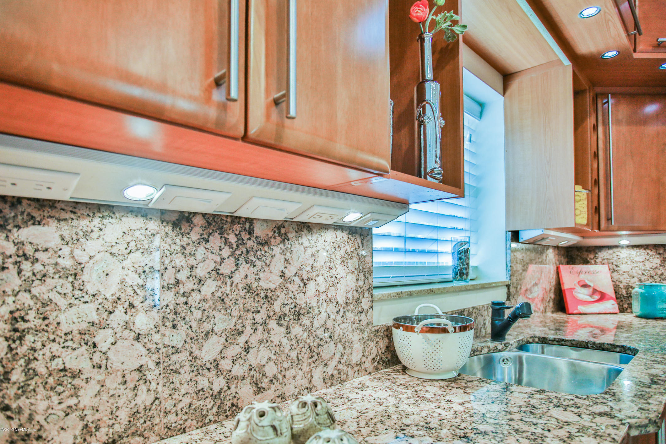 7936 Pine Lake Road Jacksonville, FL 32256 - Photo 27 of 70 a bathroom with a sink and a mirror