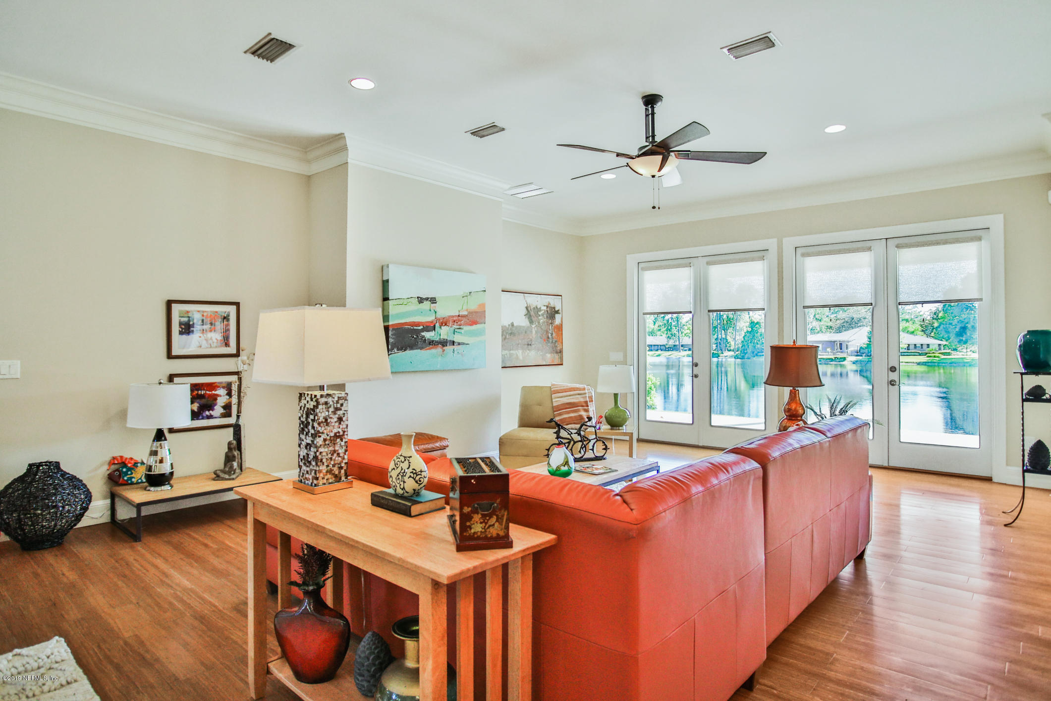 7936 Pine Lake Road Jacksonville, FL 32256 - Photo 30 of 70 a living room with furniture a wooden floor and a window