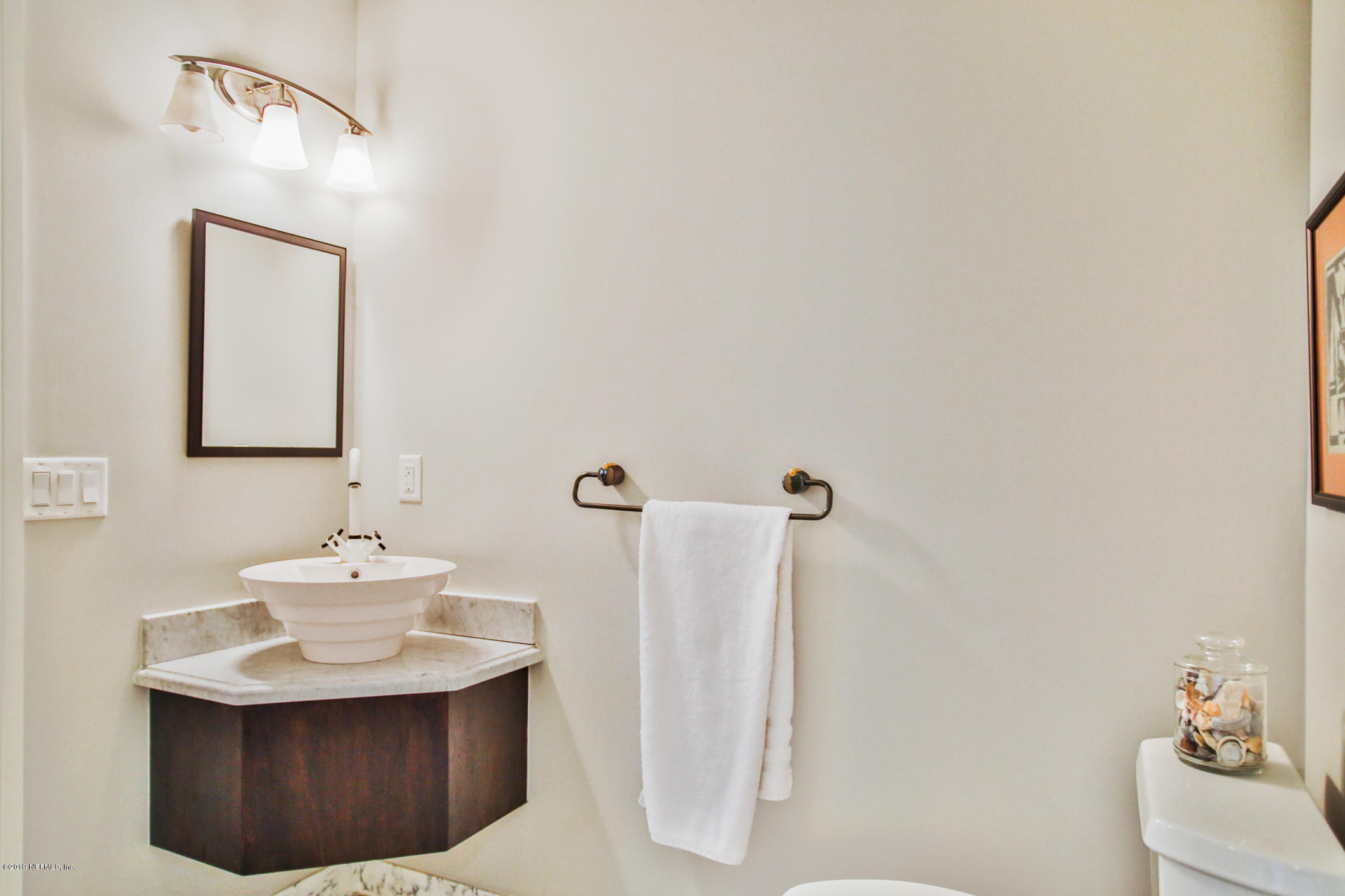 7936 Pine Lake Road Jacksonville, FL 32256 - Photo 37 of 70 a bathroom with a sink a mirror and a toilet