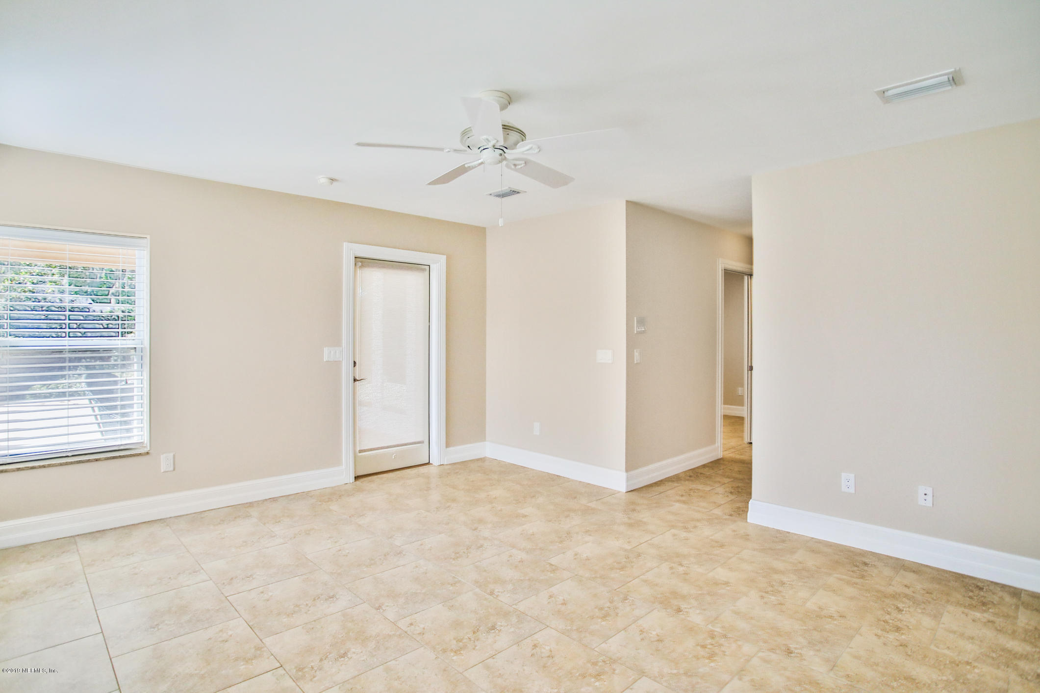 7936 Pine Lake Road Jacksonville, FL 32256 - Photo 46 of 70 an empty room with a ceiling fan and a window