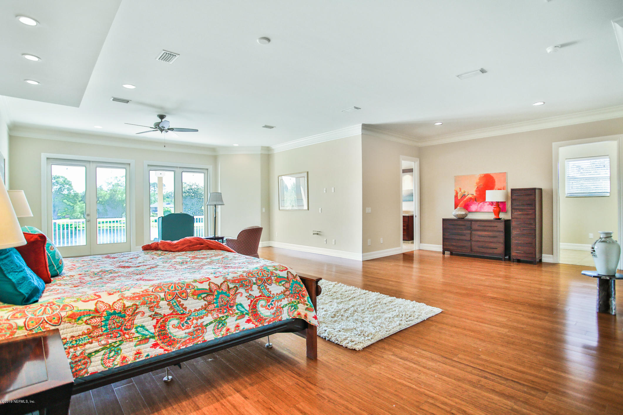 7936 Pine Lake Road Jacksonville, FL 32256 - Photo 48 of 70 a bedroom with a bed and wooden floor