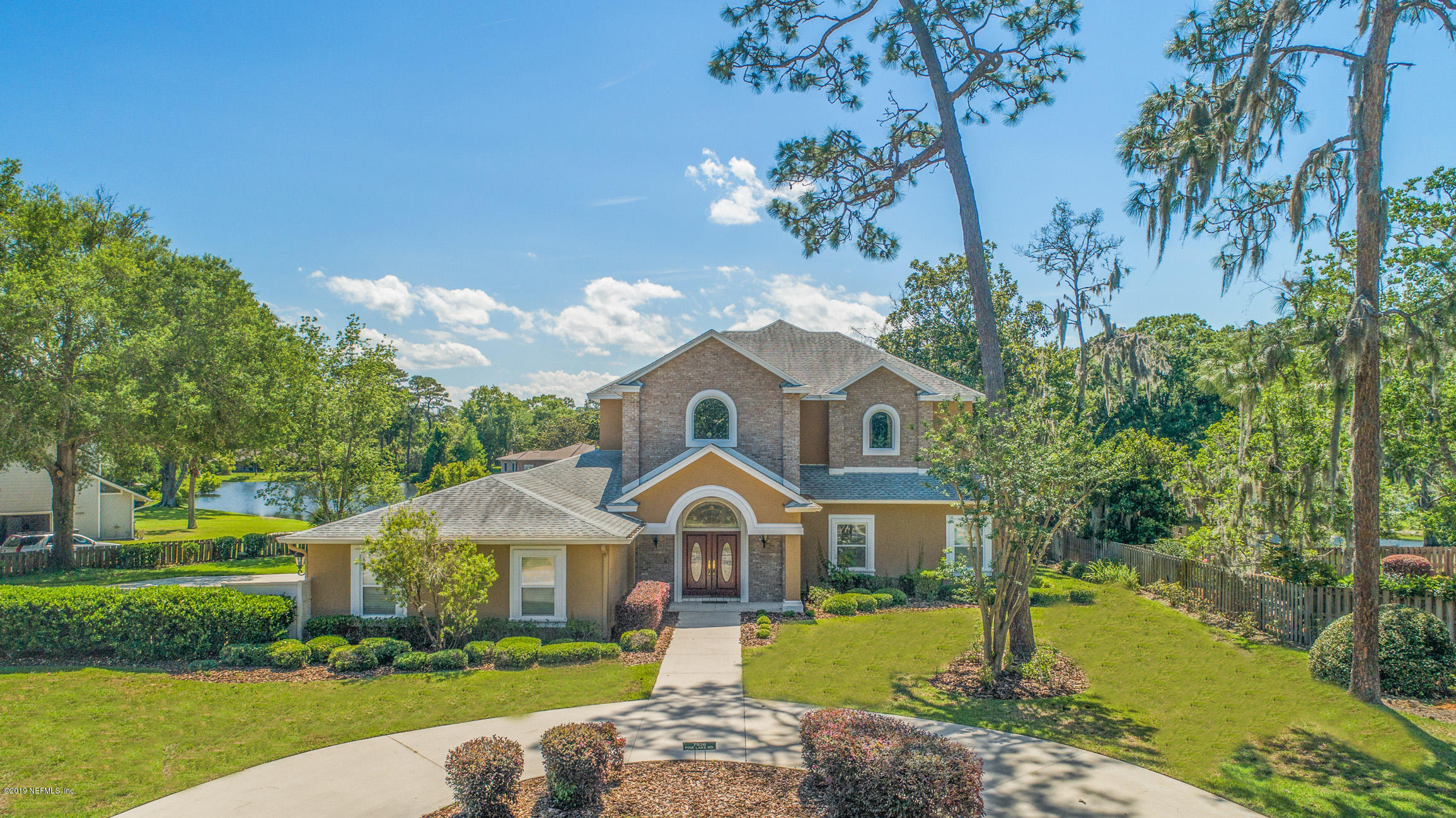 7936 Pine Lake Road Jacksonville, FL 32256 - Photo 5 of 70 a front view of a house with garden