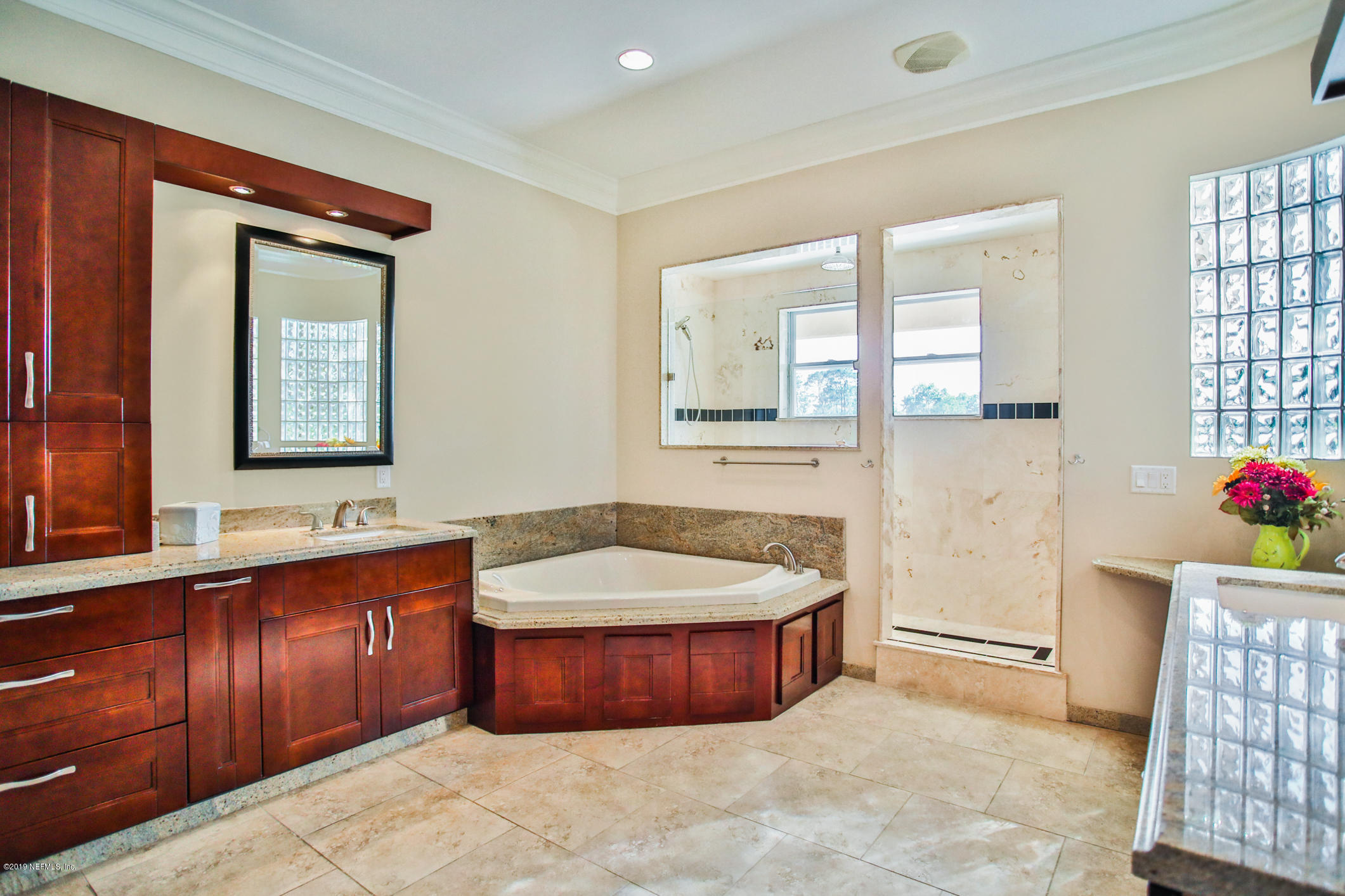 7936 Pine Lake Road Jacksonville, FL 32256 - Photo 52 of 70 a spacious bathroom with a tub sink and mirror
