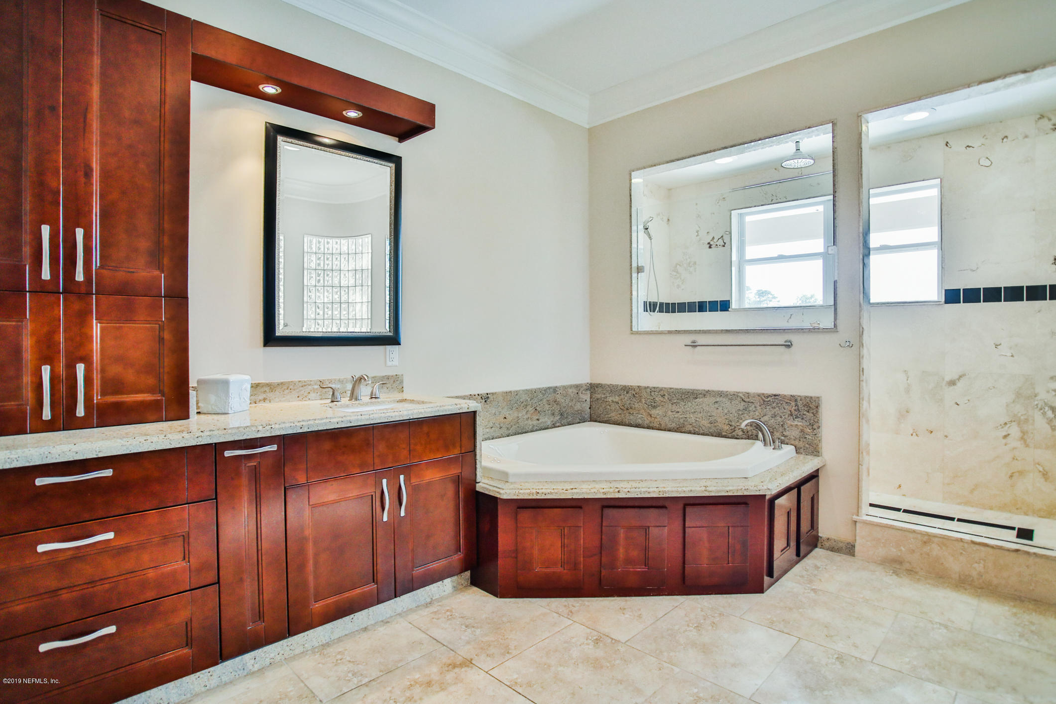 7936 Pine Lake Road Jacksonville, FL 32256 - Photo 53 of 70 a bathroom with a tub sink and mirror