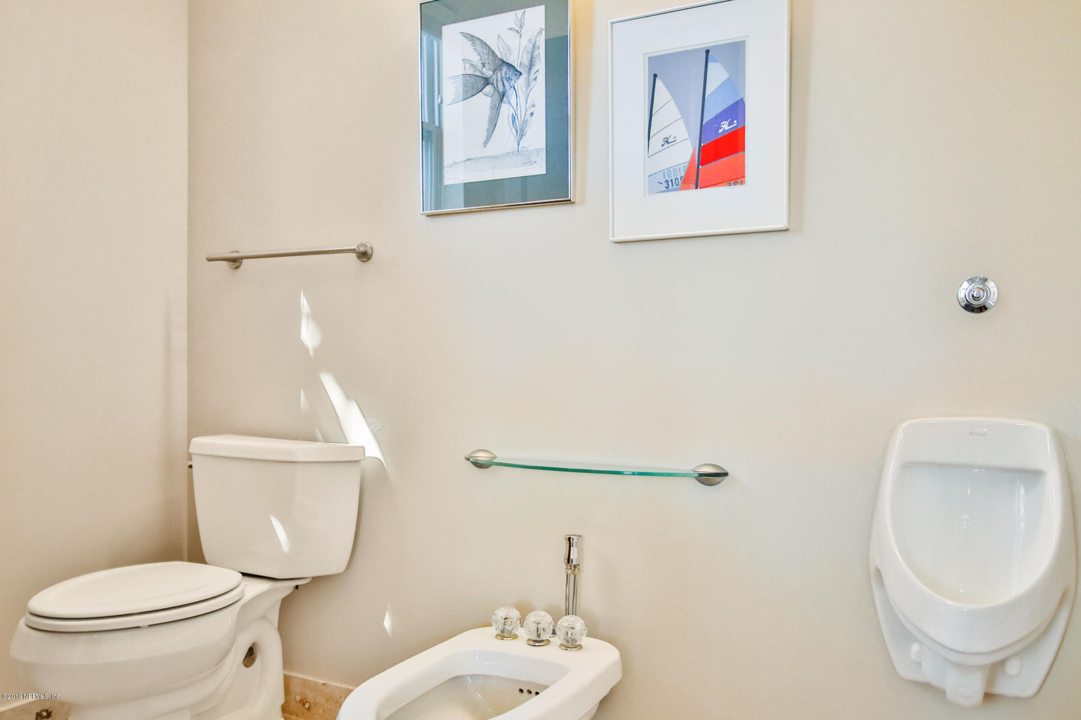 7936 Pine Lake Road Jacksonville, FL 32256 - Photo 55 of 70 a white toilet sitting next to a bathroom sink and a mirror