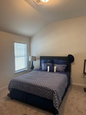 a bedroom with a bed and window