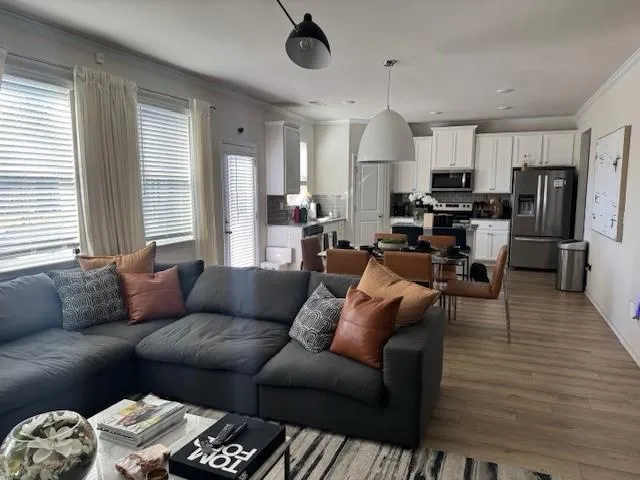a living room with furniture and wooden floor