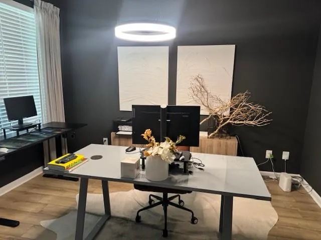 a view of a dining room with a table and chairs
