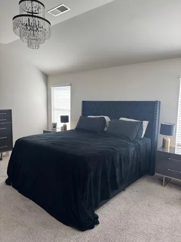 a bedroom with a bed and a table in it
