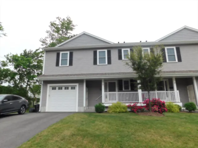 a front view of a house with a garden