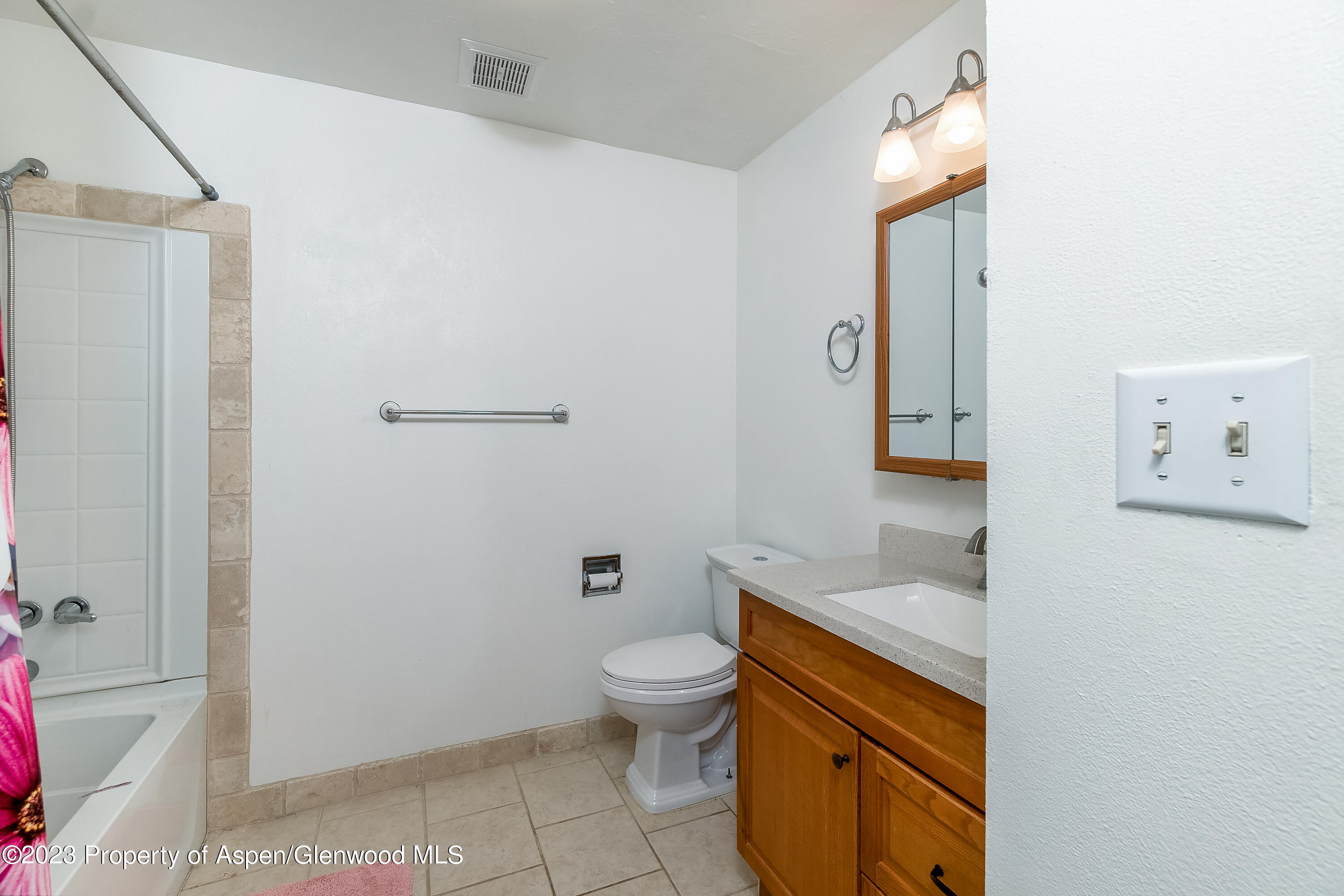 51 Hackberry Lane Parachute, CO 81635 - Photo 11 of 17 a bathroom with a granite countertop sink a toilet and a mirror