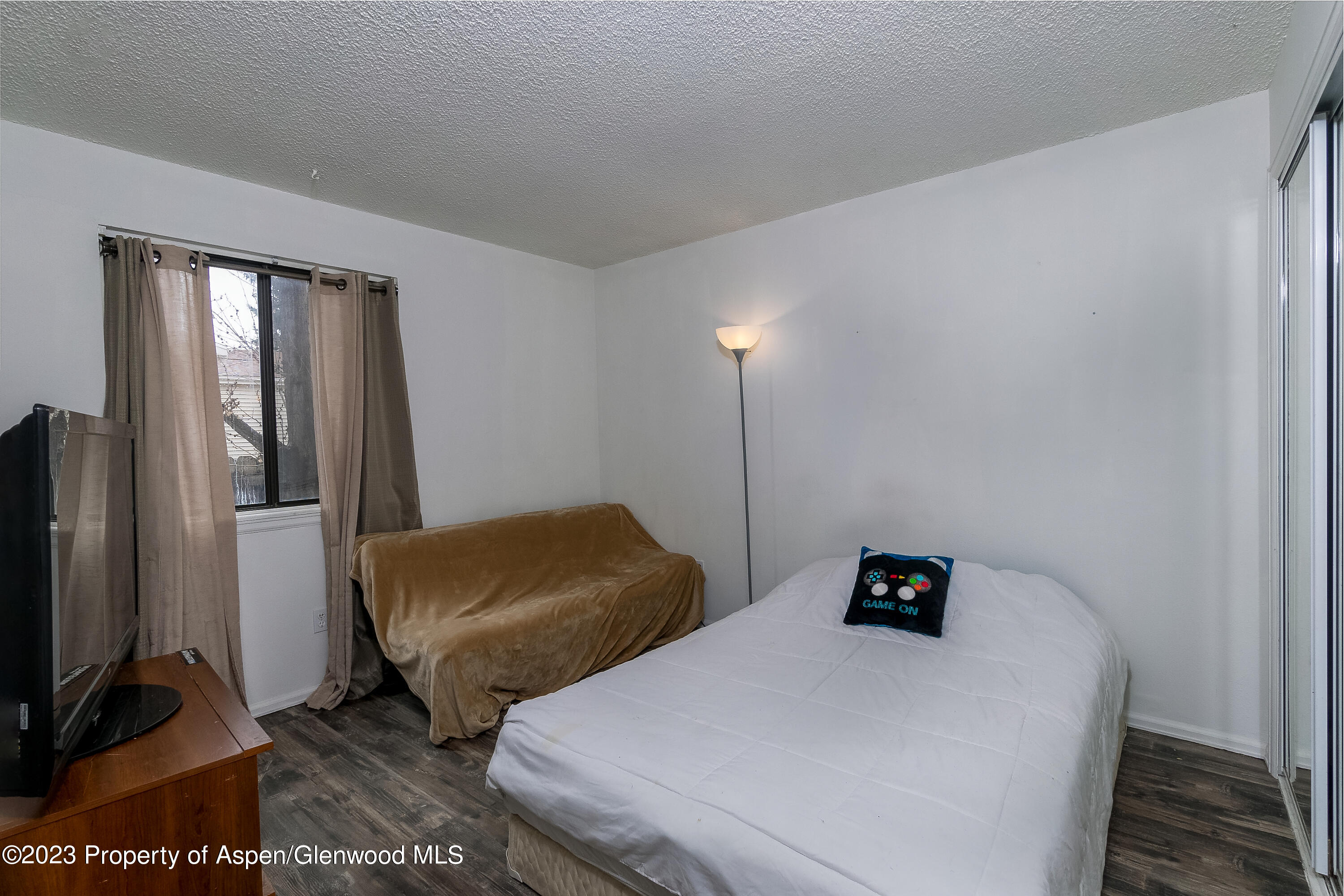 51 Hackberry Lane Parachute, CO 81635 - Photo 15 of 17 a bedroom with two beds and a flat screen tv