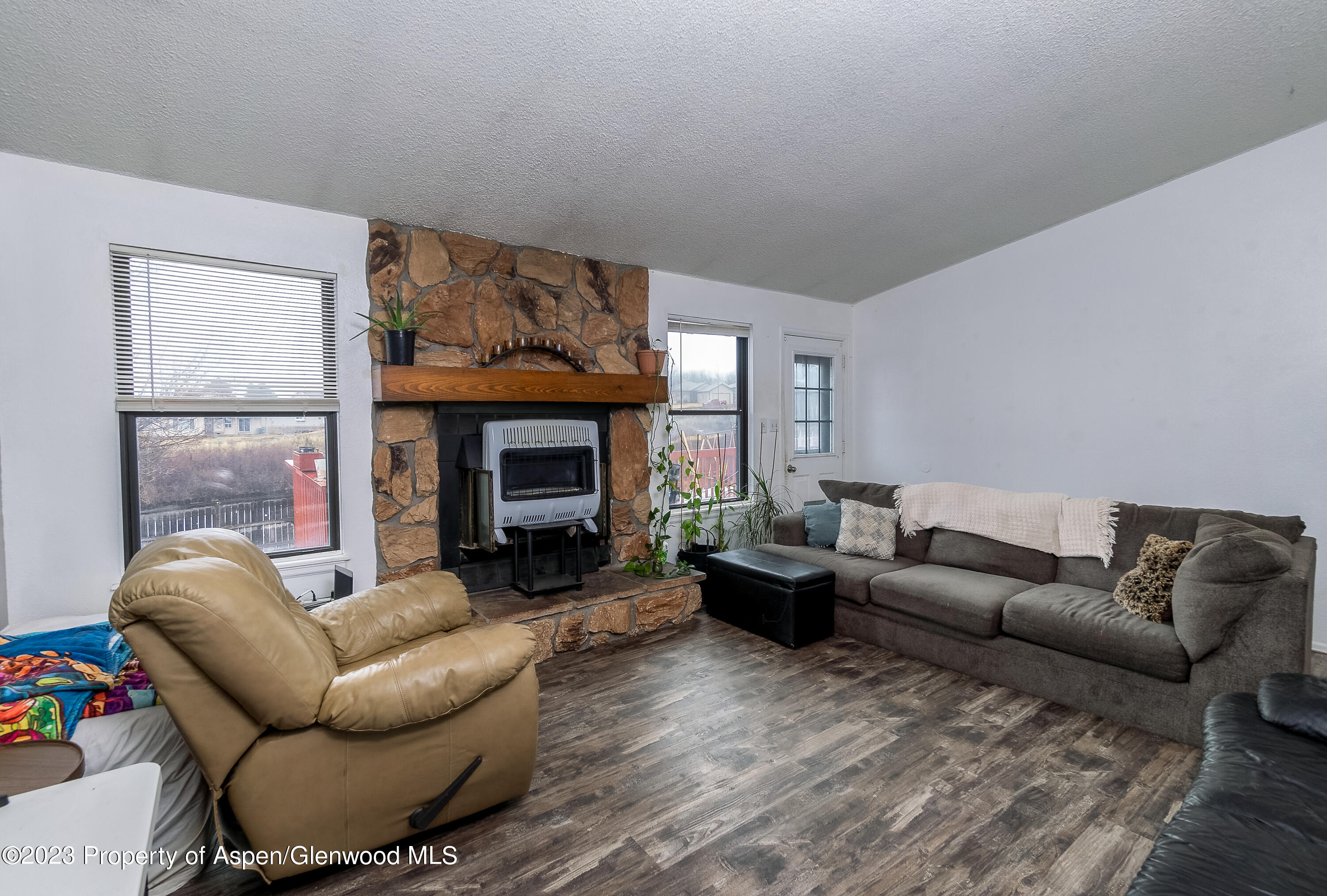 51 Hackberry Lane Parachute, CO 81635 - Photo 2 of 17 a living room with furniture a window and a fireplace