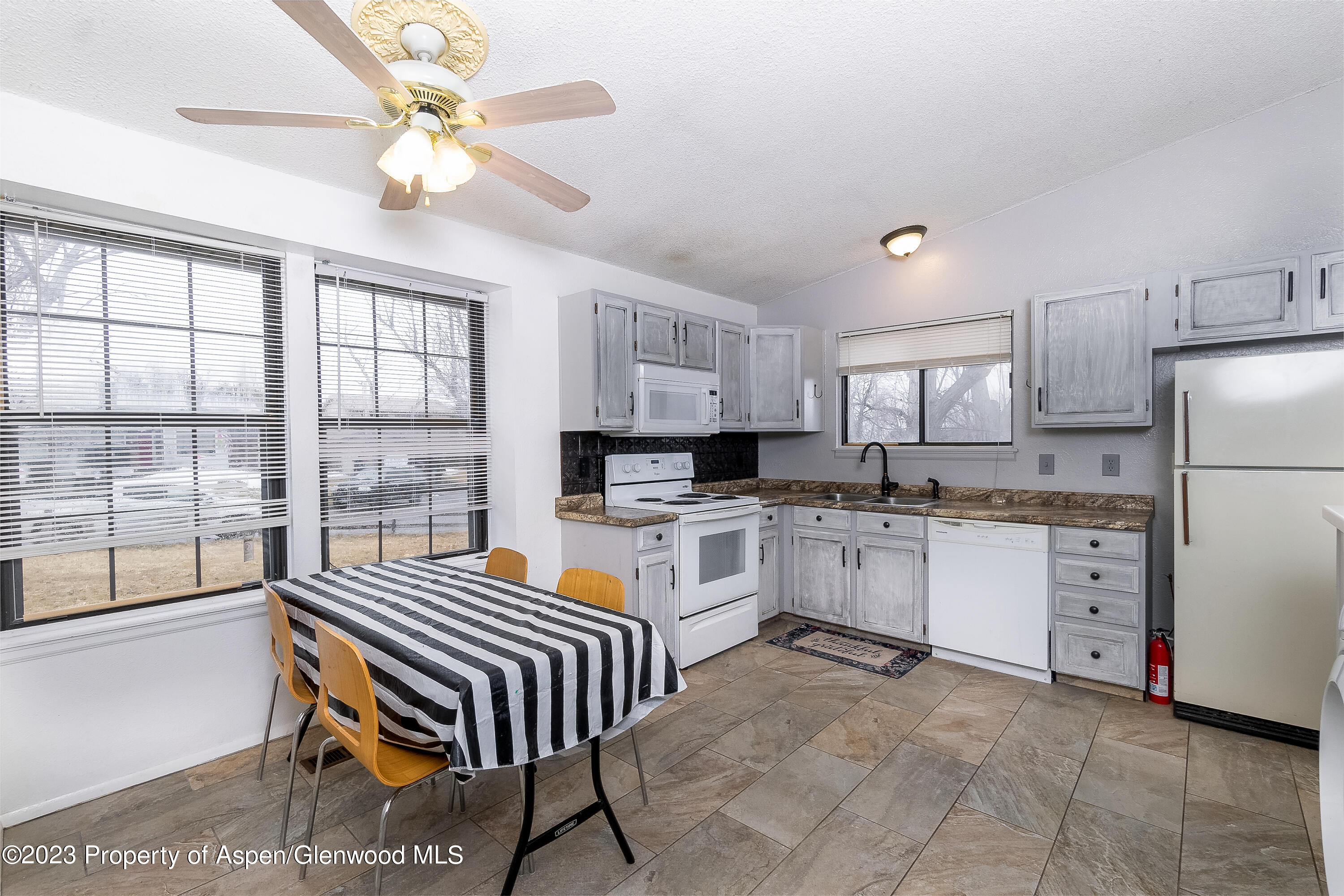 51 Hackberry Lane Parachute, CO 81635 - Photo 5 of 17 a kitchen with a refrigerator a stove cabinets and living room view
