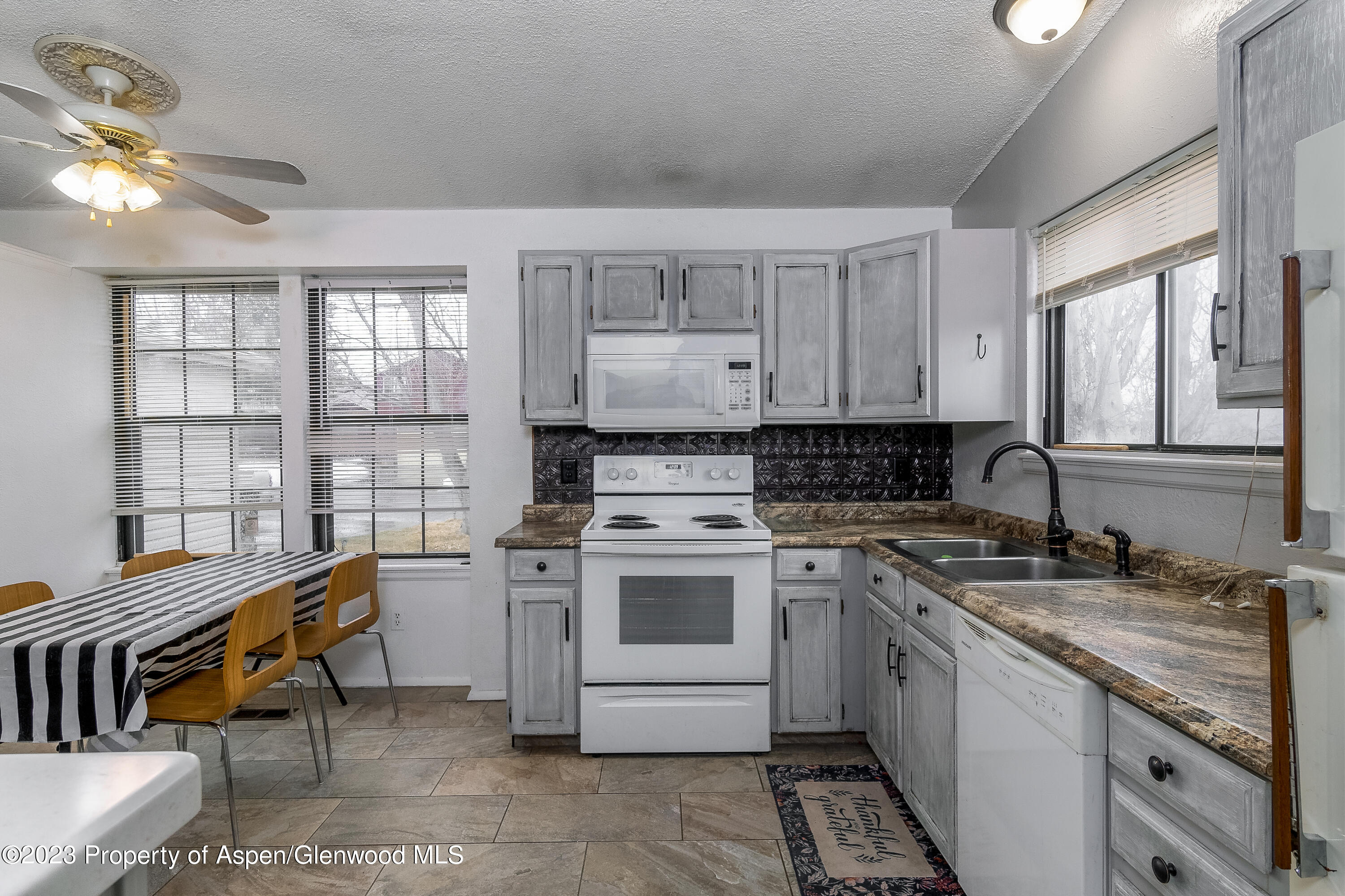 51 Hackberry Lane Parachute, CO 81635 - Photo 6 of 17 a kitchen with a stove sink and cabinets